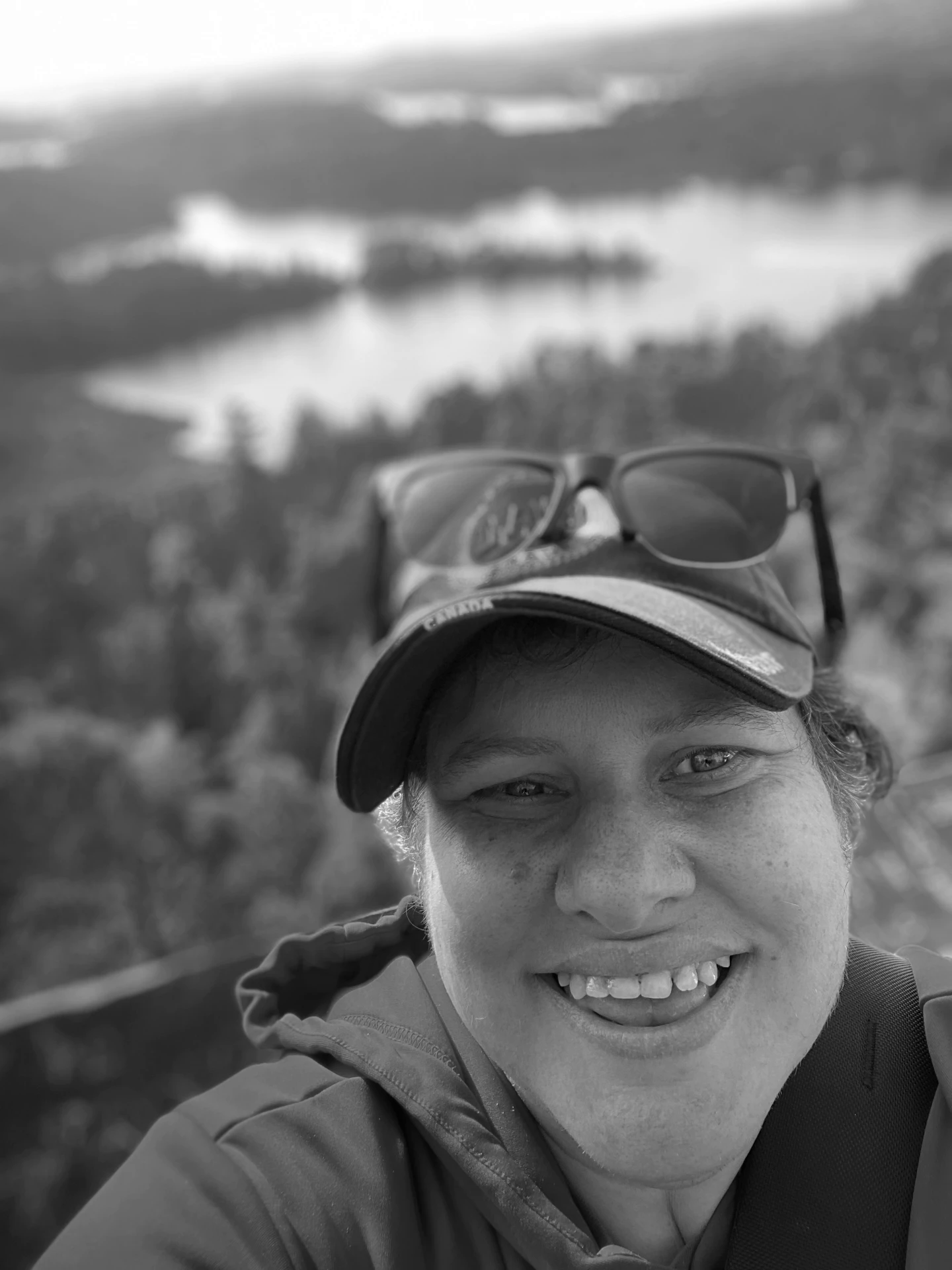Black-and-white photo of Kate Thornton outdoors in a Canada cap